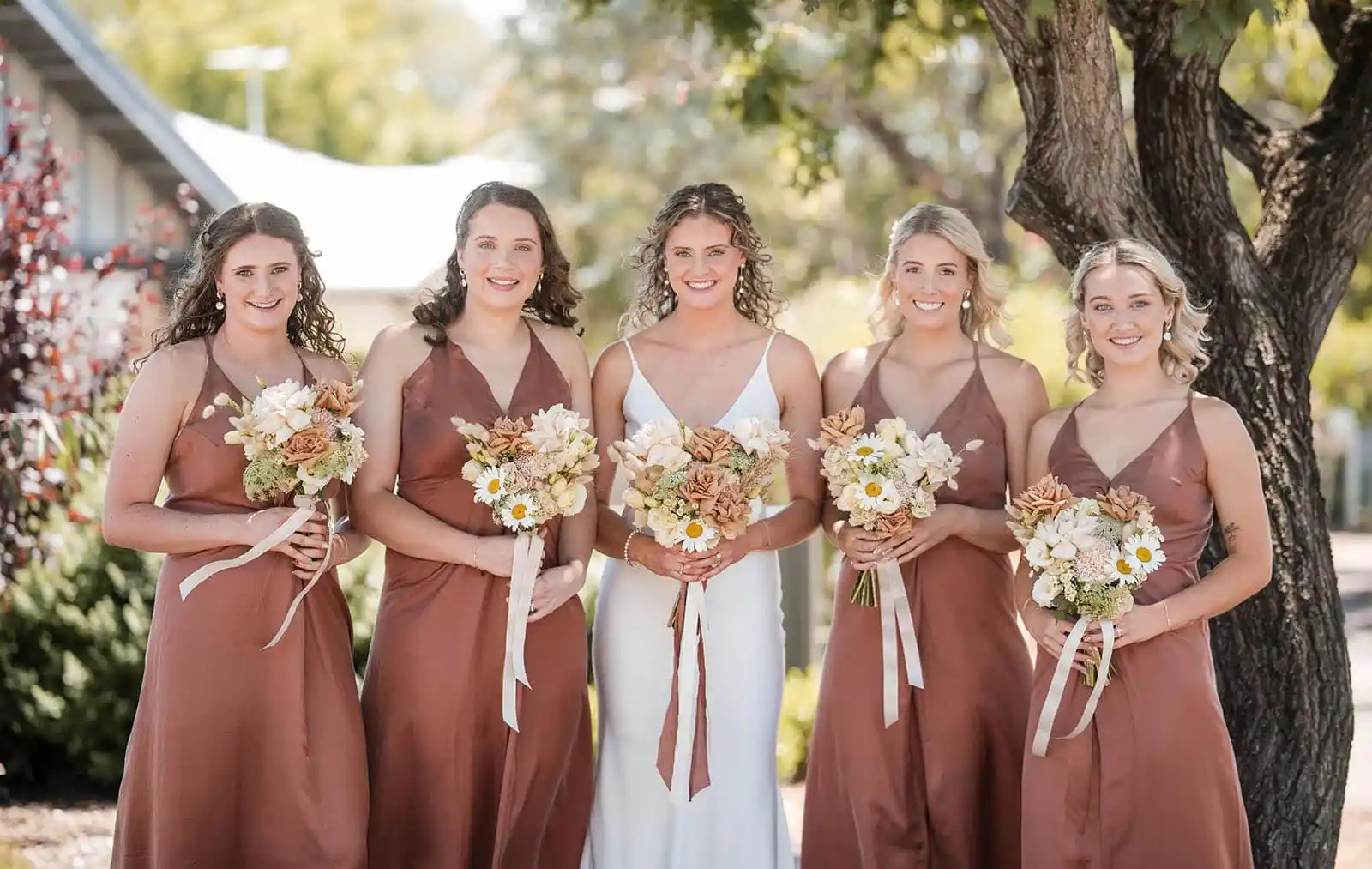 bridesmaids holding boquets